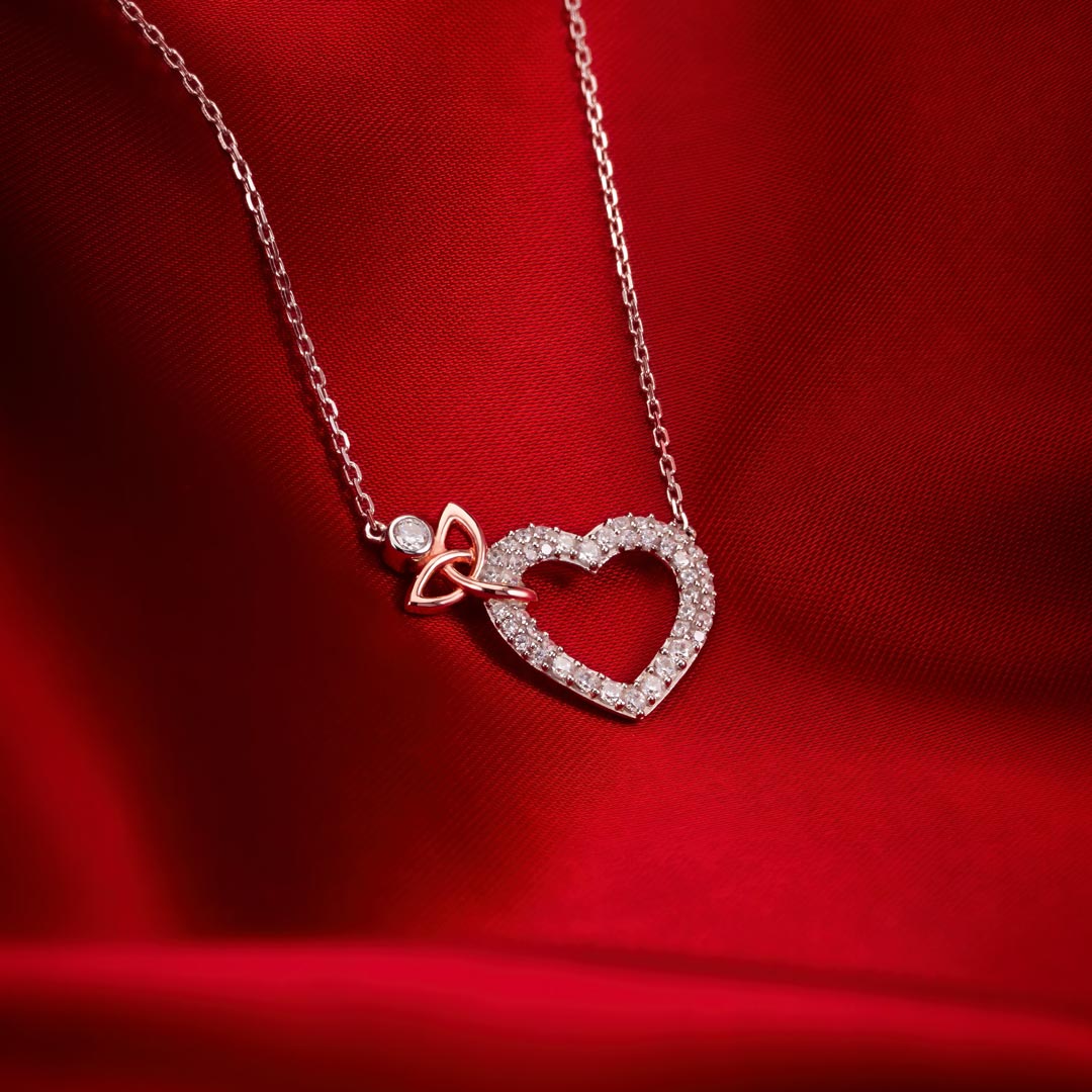 styled image of celtic heart necklace on red background