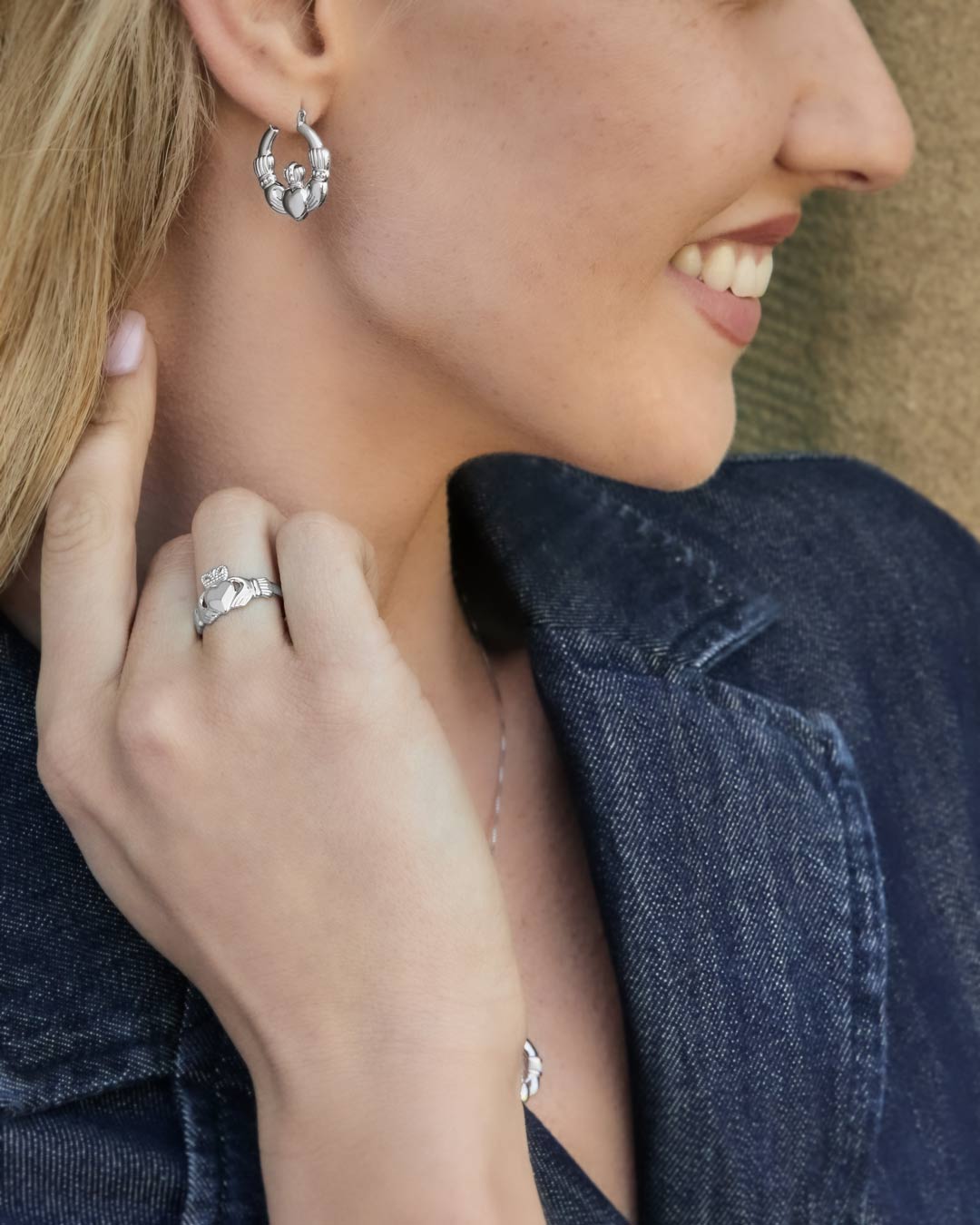 silver claddagh ring and claddagh creole earrings on model
