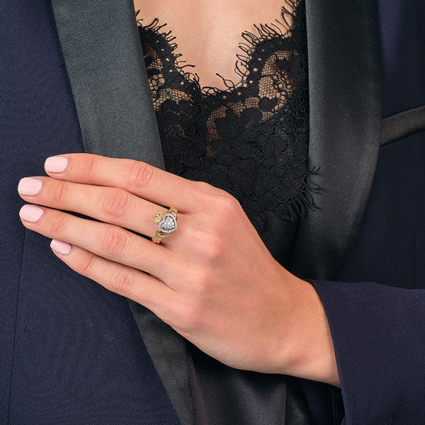a model wearing the Claddagh ring on her left hand with the heart facing towards hers implies she is happily married