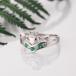 lifestyle image of Claddagh wishbone ring on white background