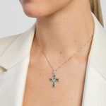 model wearing green marble celtic cross pendant with claddagh symbol in centre