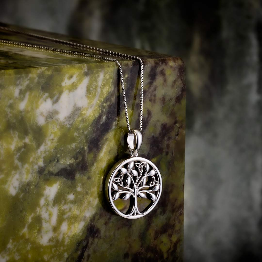 lifestyle image of silver connemara marble tree of life necklace s46669 on green marble stone 1