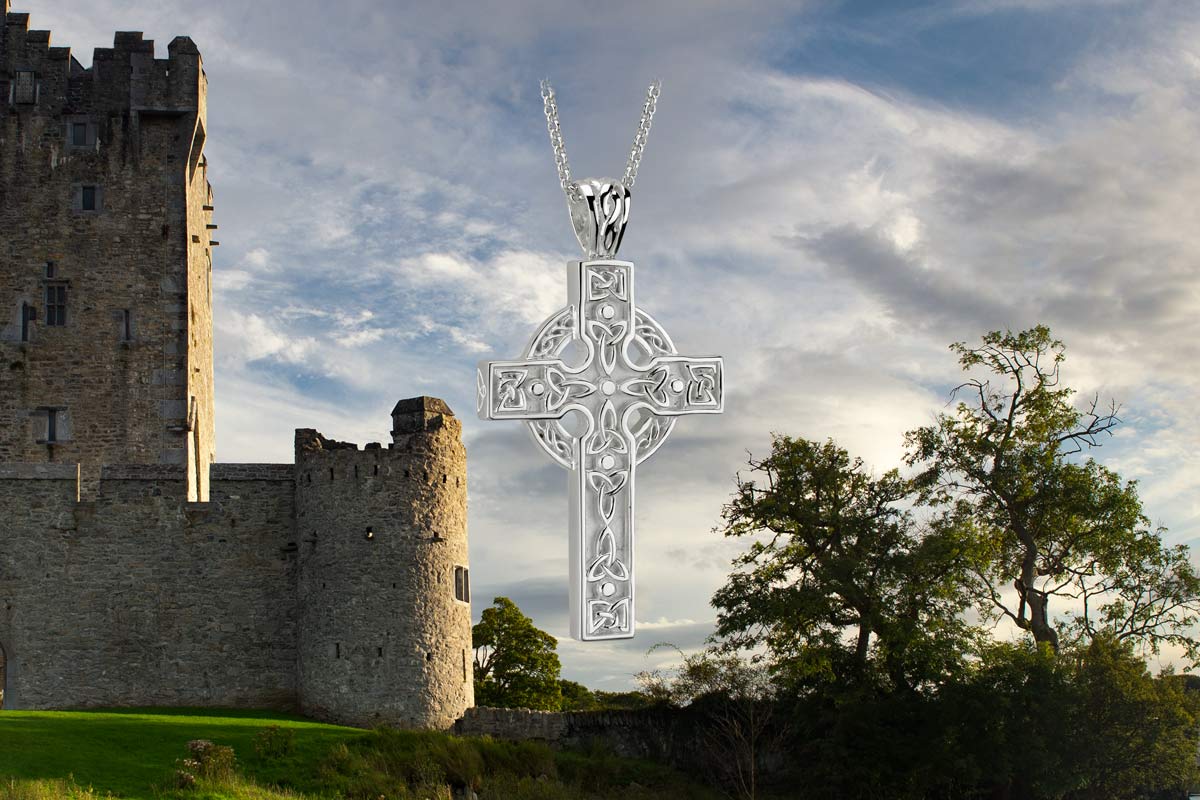 styled image of celtic cross necklace in irish landscape background
