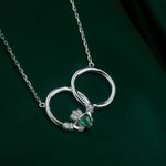 styled image of crystal claddagh circle pendant on green background