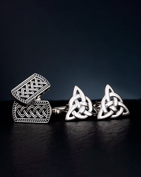 lifestyle image of two sets of silver celtic cufflinks
