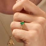 closeup image of yellow gold emerald Celtic Knot Ring on a model