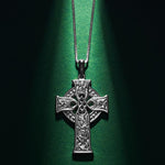 styled image of small four apostles celtic cross pendant s46604 on green background