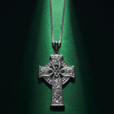styled image of small four apostles celtic cross pendant s46604 on green background