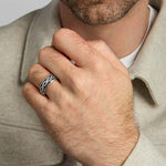 closeup image of men's celtic knot band ring in silver