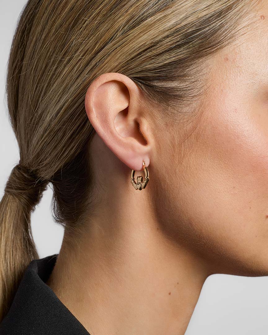 gold claddagh creole small earrings from Solvar on a model