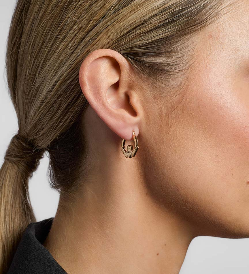 gold claddagh creole small earrings from Solvar on a model