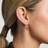 model wearing yellow gold Claddagh hoop earrings from Solvar