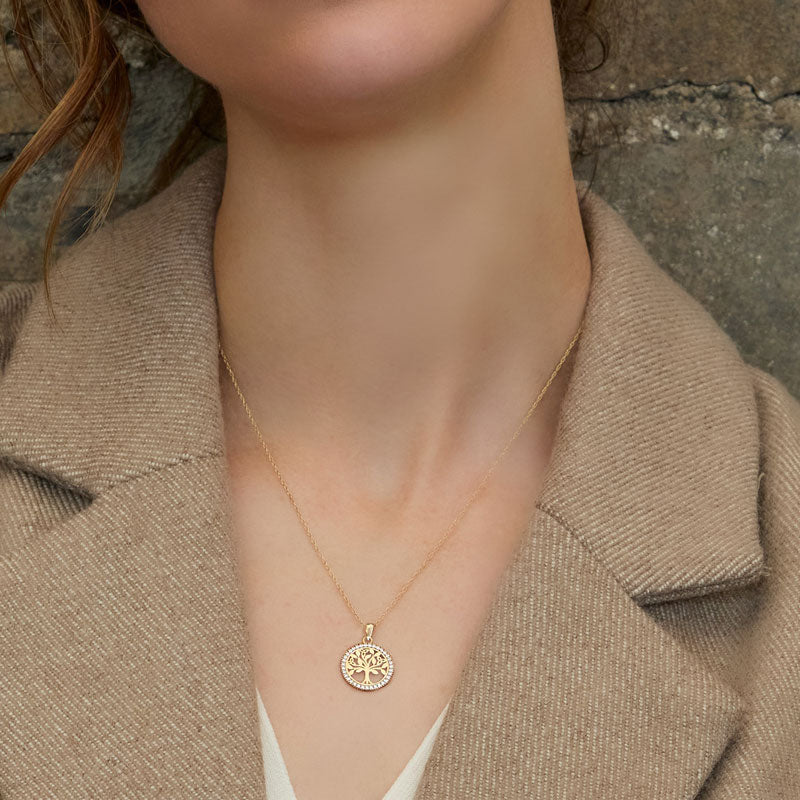 a model wearing yellow gold round Celtic tree of life necklace from Solvar