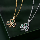 styled image of matching white and yellow gold emerald shamrock pendants