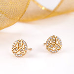 styled image of gold trinity knot stud earrings