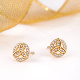 styled image of gold trinity knot stud earrings