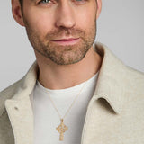 a male model wearing hand engraved yellow gold heavy Celtic cross from Solvar
