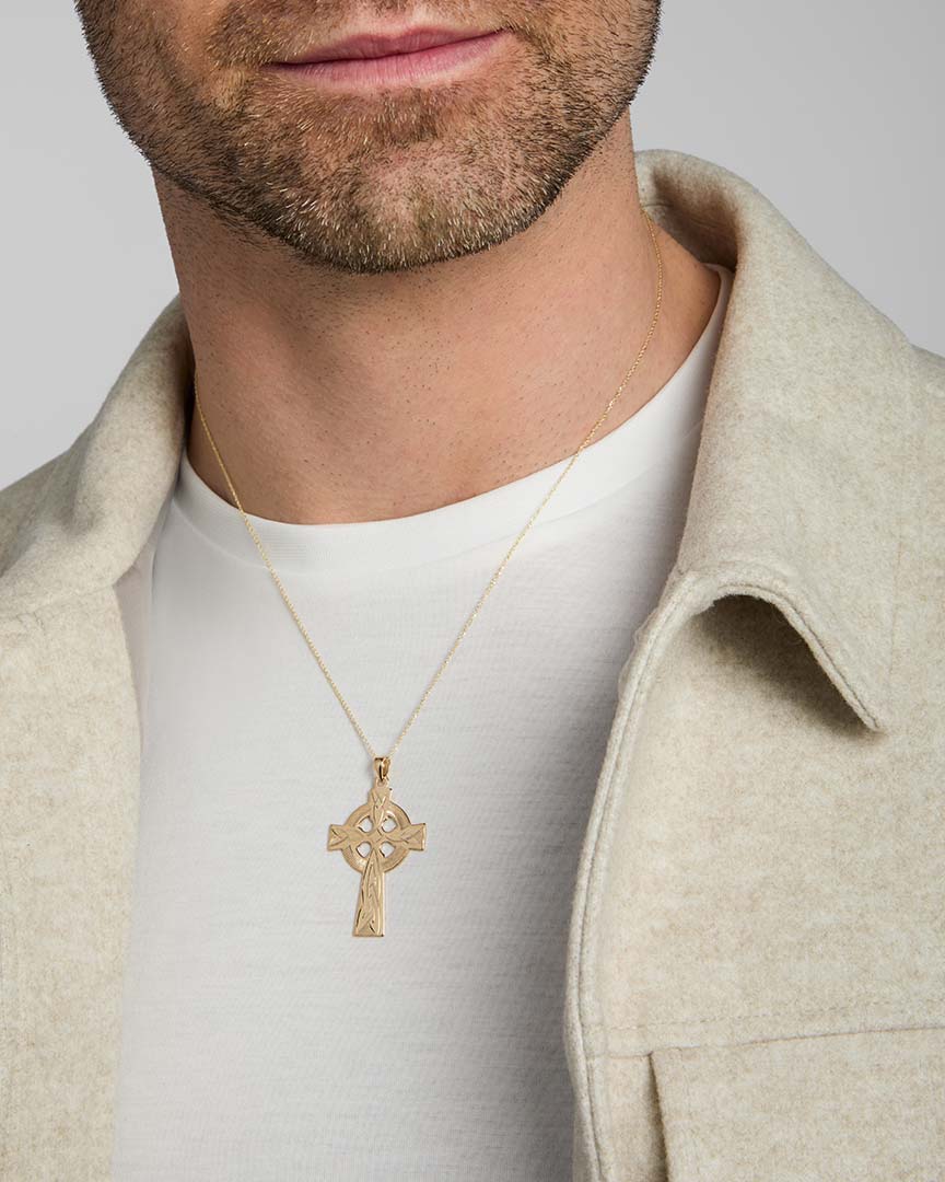 men's 14k gold hand-engraved heavy celtic cross on a model