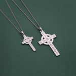 light and heavy History of Ireland cross necklaces on a green background