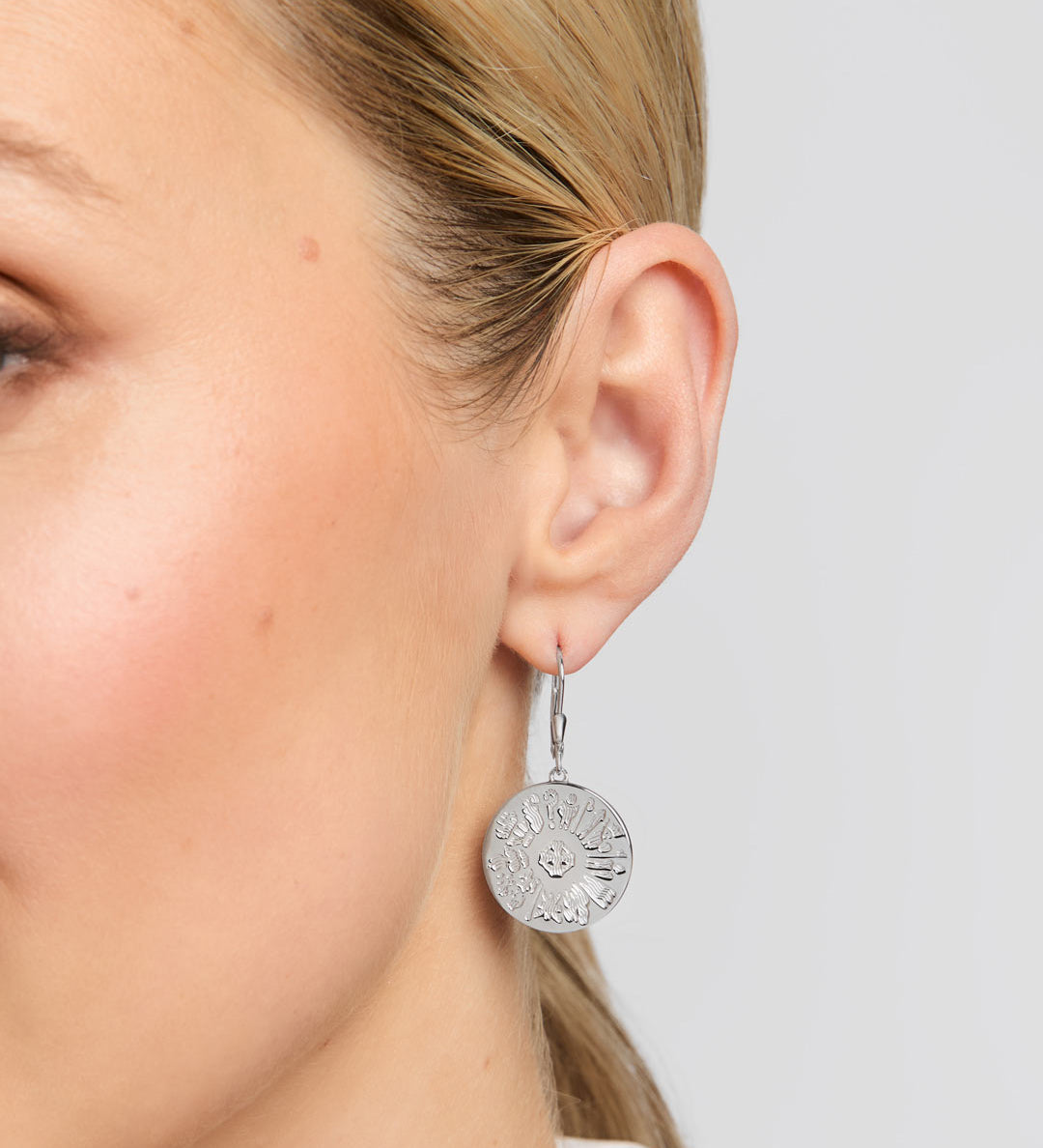 History of Ireland disc earrings on a model