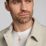 a male model wearing large yellow gold celtic cross pendant