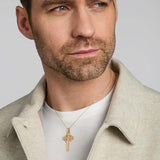 a male model wearing large yellow gold celtic cross pendant