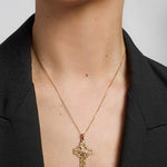 gold large embossed celtic cross on a female model
