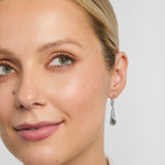 Connemara marble trinity knot set drop earrings on a model