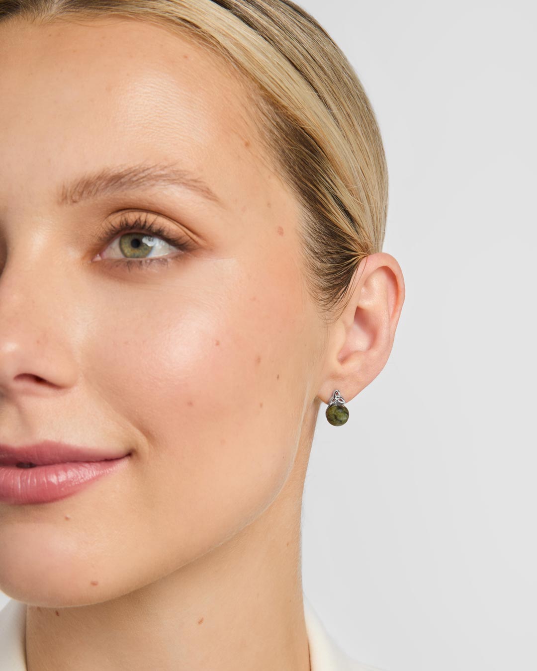Connemara marble celtic stud earrings on a model