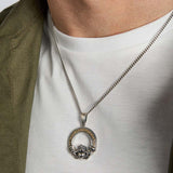 closeup image of men's mixed metal heavy Celtic Claddagh pendant on model
