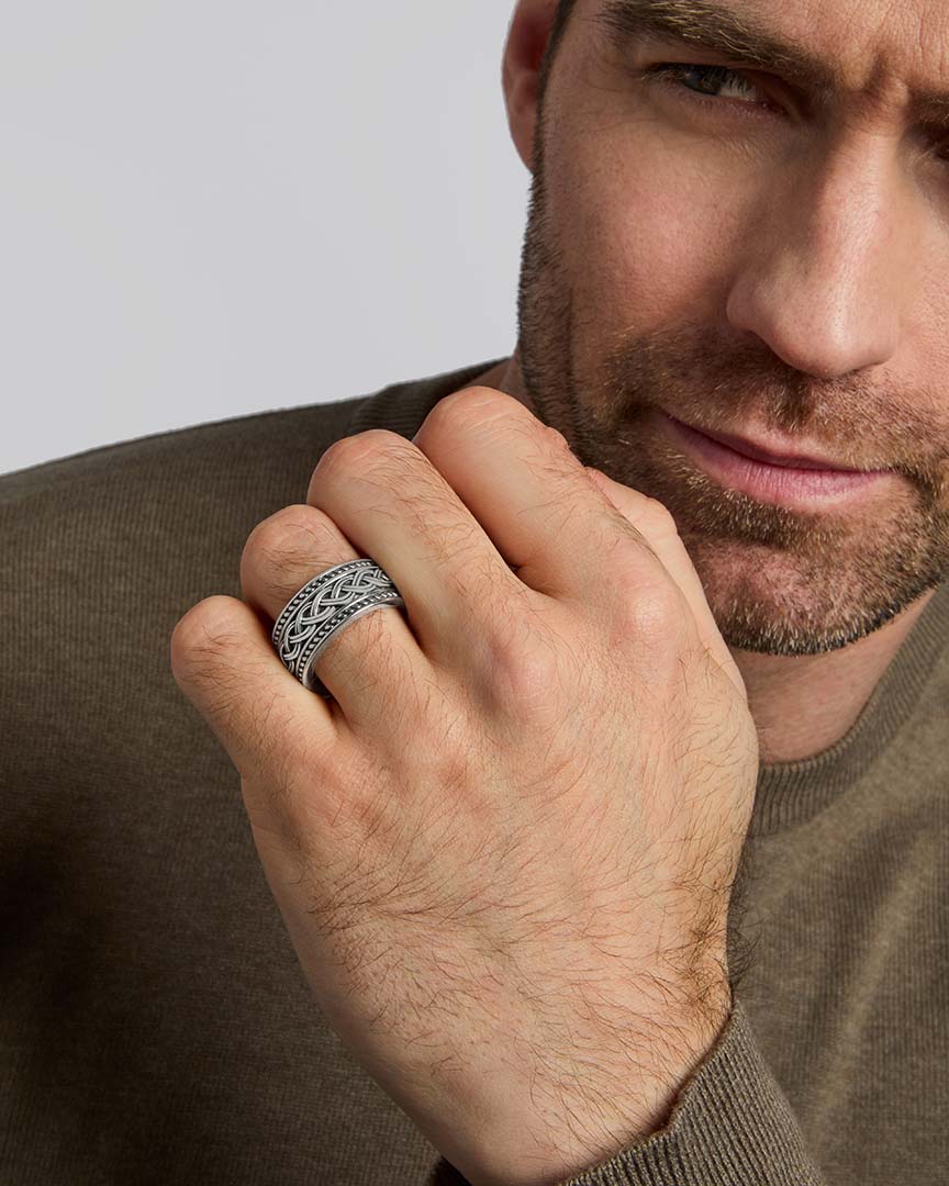 closeup image of mens heavy Celtic Knot ring on a model