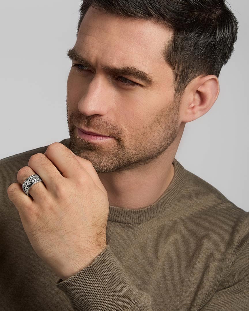 a model wearing silver men's heavy Celtic knot ring from Solvar