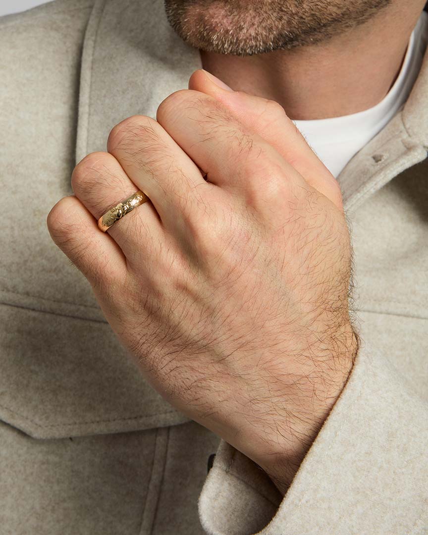 closeup image of men's gold claddagh wedding band ring