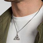 closeup image of men's large Celtic Knot pendant in silver on a model