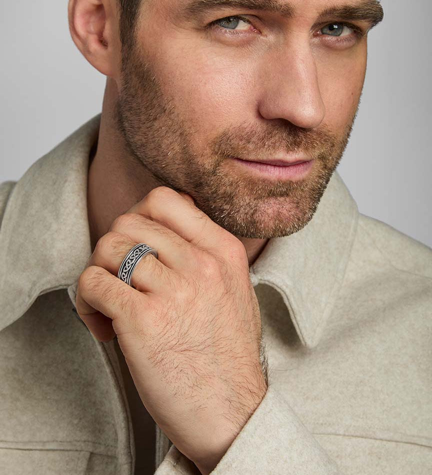 a male model wearing oxidised silver Celtic Knot band ring from Solvar
