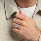 closeup image of oxidised silver men's Trinity Knot band ring on a model