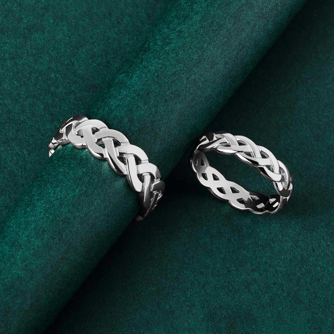 his and hers silver Celtic Knot rings in silver on green background