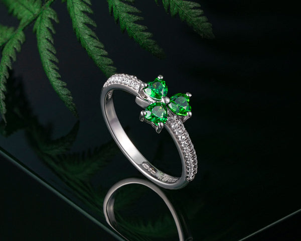 green crystal shamrock ring styled on a dark background