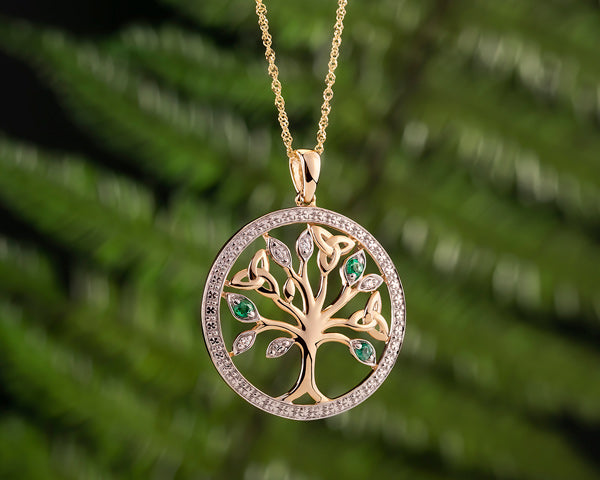 tree of life necklace styled on a green background