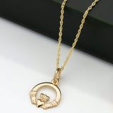 lifestyle image of small gold Claddagh pendant