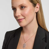 Female model wearing a luxurious Solvar Celtic knot necklace featuring shimmering diamonds