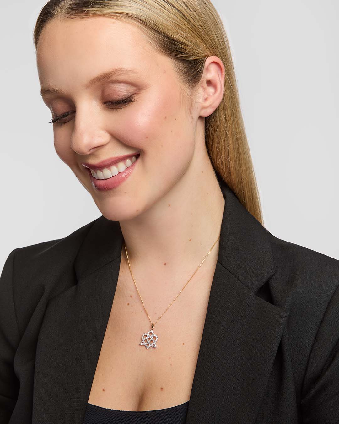 Diamond heart and Celtic knot pendant necklace on model
