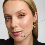 Model showcasing a Solvar gold Claddagh heart necklace, beautifully highlighting the large heart-shaped diamond.