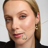 Model showcasing a Solvar gold Claddagh heart necklace, beautifully highlighting the large heart-shaped diamond.