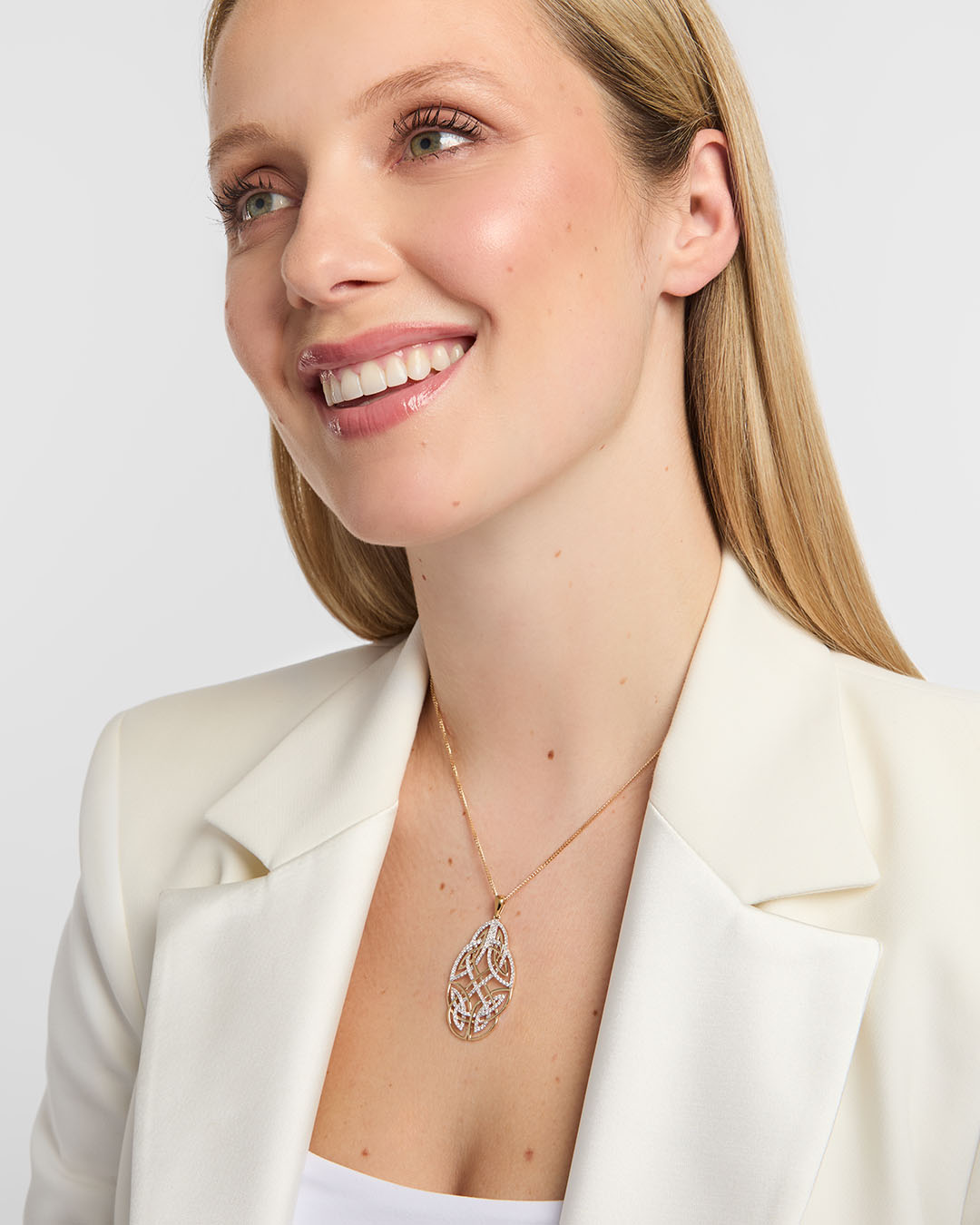 woman showcasing a statement diamond celtic knot necklace made by Solvar