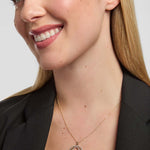 Model wearing a Solvar 14k gold round  Celtic knotwork pendant showcasing large diamond Claddagh heart