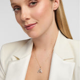 model wearing 14K gold Trinity Knot pendant with sparkling diamonds, symbolising eternal love and Irish heritage in an elegant design