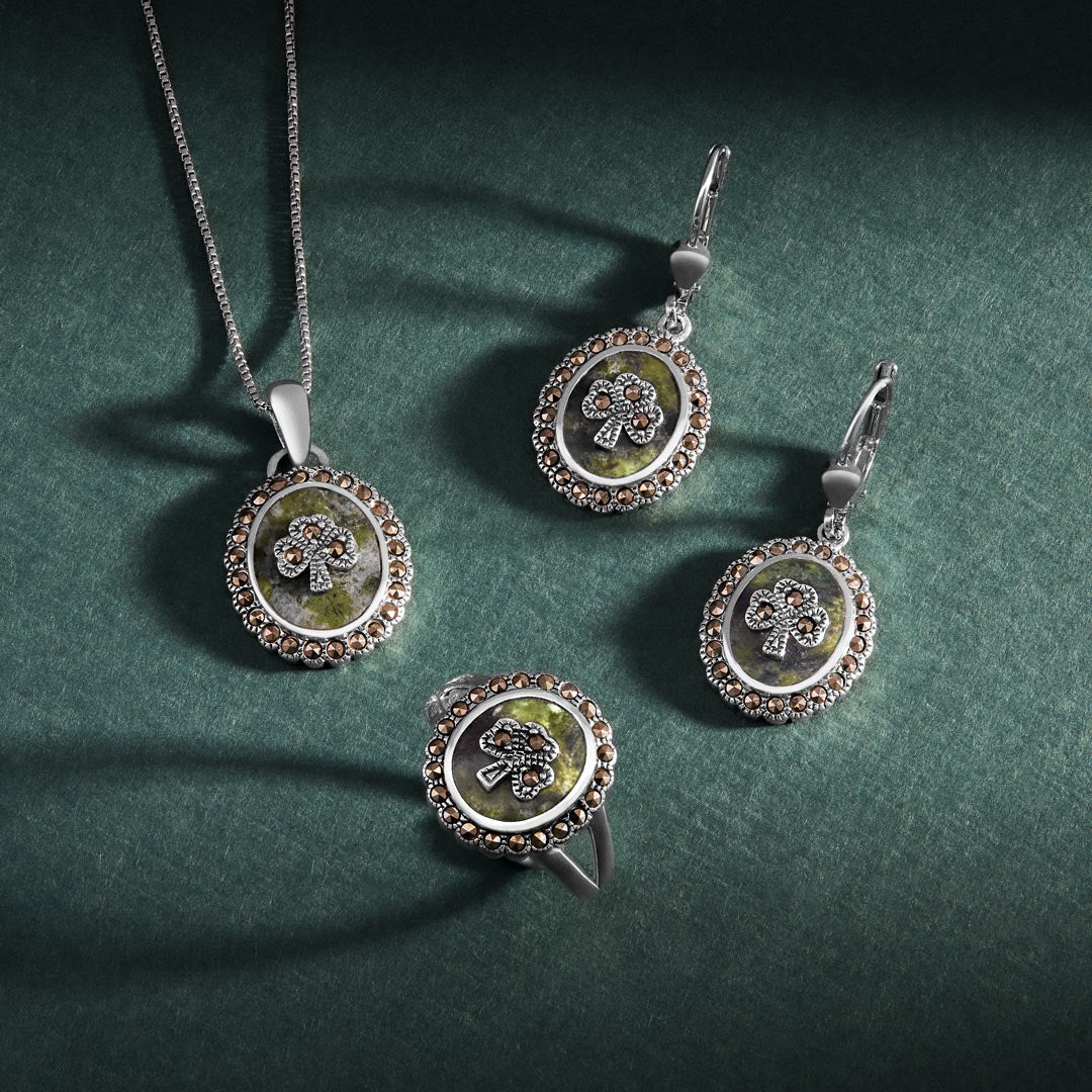 lifestyle image of matching connemara marble marcasite shamrock necklace, earrings, and ring