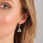 a model wearing Solvar flush set cz trinity knot drop earrings s34212