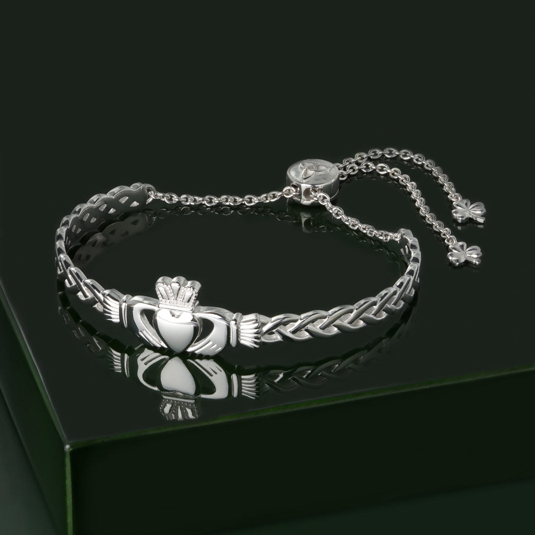 lifestyle image of celtic claddagh bangle on green background